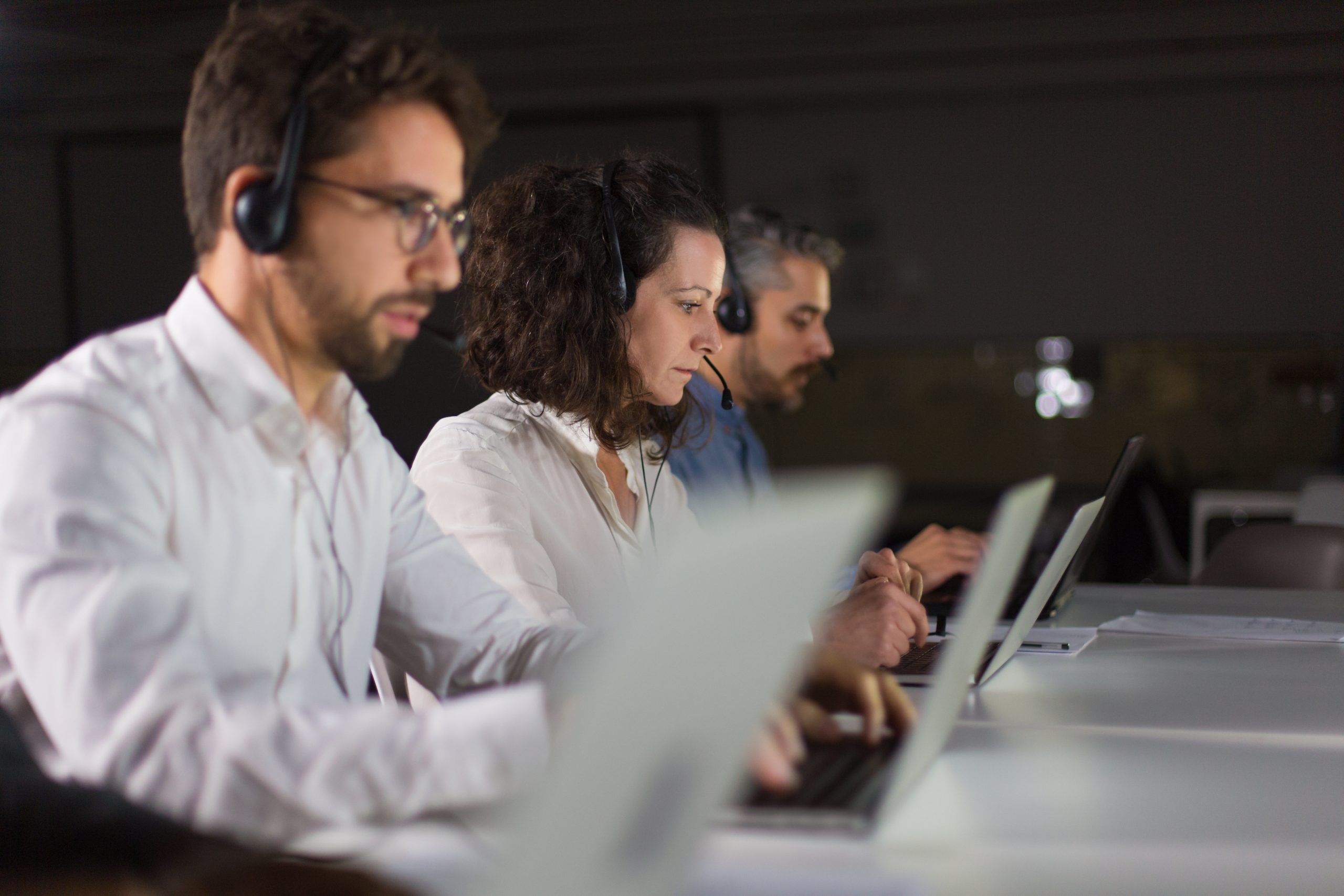 Client support team at workplace. Thoughtful call center operators during working process. Call center concept